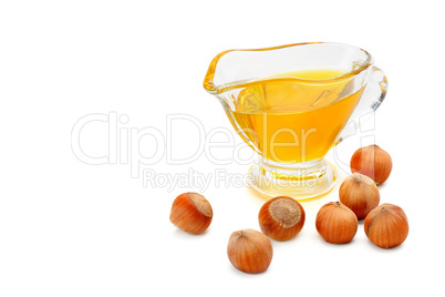 Oil and fruit hazelnut isolated on white. Free space for text.