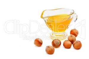 Oil and fruit hazelnut isolated on white. Free space for text.