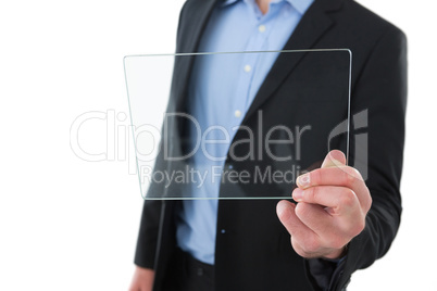 Mid section of businessman holding transparent glass interface