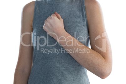Mid section of businesswoman with hand on chest