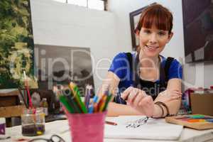 Beautiful woman sketching in drawing book