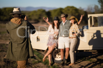 Man taking a picture of his friends during safari vacation