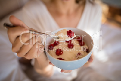 Mid section of woman having breakfast