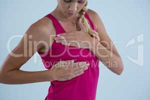 Woman touching breast for lumps
