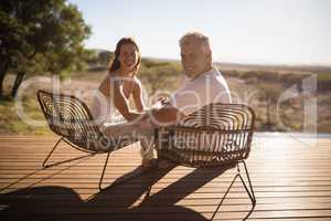 Senior couple sitting on chairs at the resort