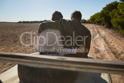 Rear view of couple on off road vehicle