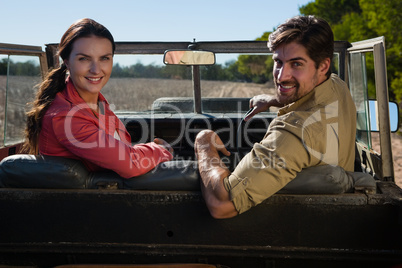 Portrait of couple sitting in off road vehicle