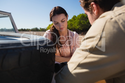 Woman with man by off road vehicle