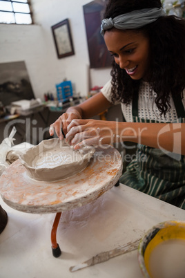 Happy woman molding clay