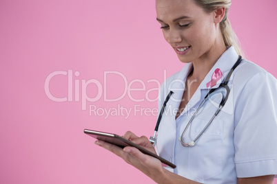 Smiling young female doctor using tablet computer Smiling young female doctor using tablet computer