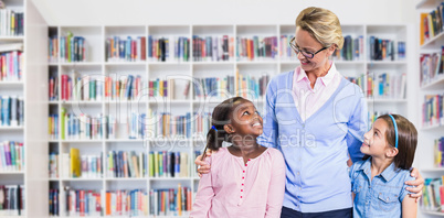 Composite image of smiling teacher with students