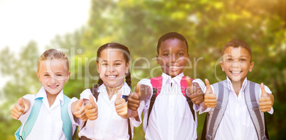 Composite image of portrait of students showing thumbs up sign