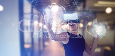 Composite image of cheerful businesswoman gesturing while looking through virtual reality simulator