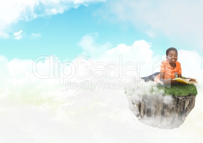 Young boy on floating rock platform  in sky reading book