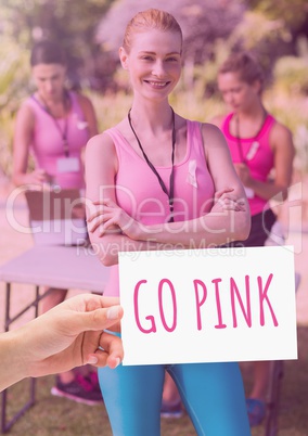 Go Pink Text and Hand holding card with pink breast cancer awareness women