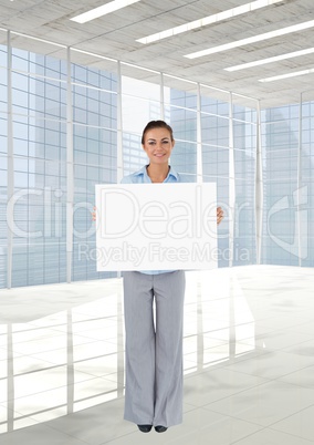 Business woman holding blank card in office