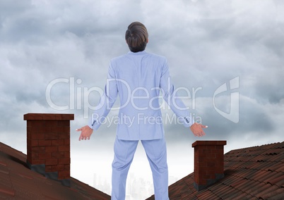 Businessman standing on Roofs with chimney and cloudy sky