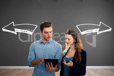 Composite image of concentrated business people using a digital tablet