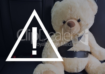 Caution sign icon against teddy bear in the car