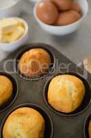 High angle view of muffins in tin by ingredients