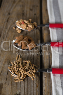 Three spoons with various breakfast cereals