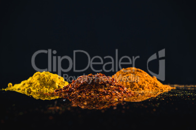 Powdered spices against black background