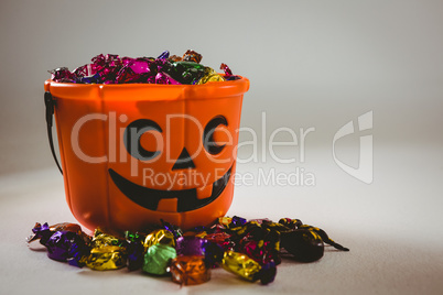 Bucket with wrapped chocolates during Halloween