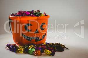 Bucket with wrapped chocolates during Halloween
