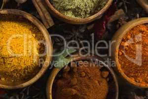 Various spice powder in wooden bowl