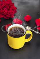 round yellow mug with hot tea on a black table