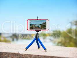 smartphone stands on a tripod