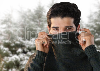 Man with warm jumper in snow forest