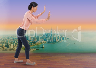 Businesswoman reaching arms like lost pushing over city