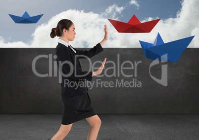 Businesswoman with paper boats