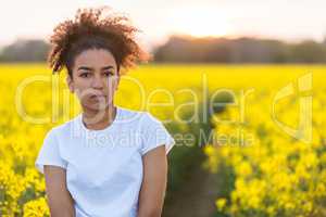 Sad Mixed Race African American Teenager Woman in Yellow Flowers