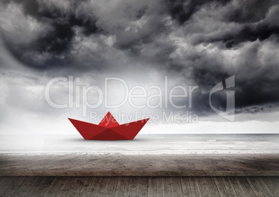 Red paper boat in sea
