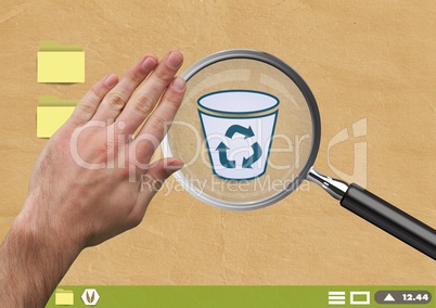 Hand touching Magnifying glass over recycle bin on Paper cut out desktop