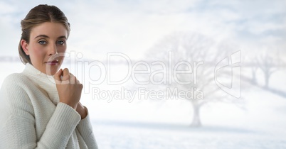 Woman in white warm jumper with bright snow landscape and bare tree