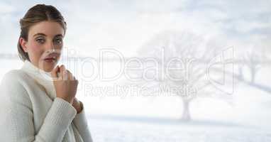 Woman in white warm jumper with bright snow landscape and bare tree