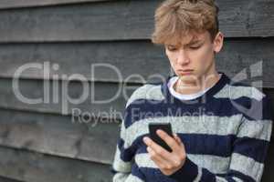 Sad Depressed Boy Male Child Teenager Using Mobile Cell Phone