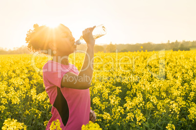 Mixed Race African American Girl Teenager Runner Drinking Water