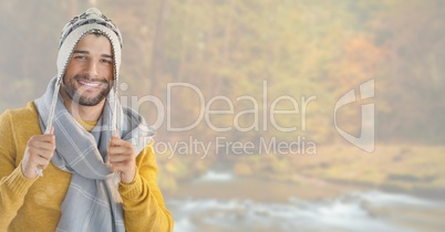 Man in Autumn with hat and scarf in bright forest