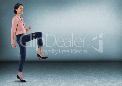 Businesswoman standing on one foot in room
