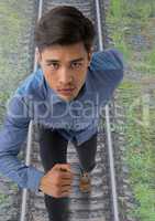 Businessman running on train tracks railway