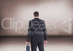 Businessman with briefcase in room