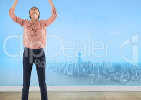 Businesswoman reaching to sky over city