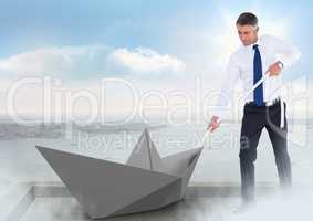 Businessman pulling paper boat with rope in city sky