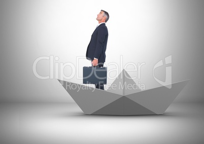 Businessman with briefcase in paper boat