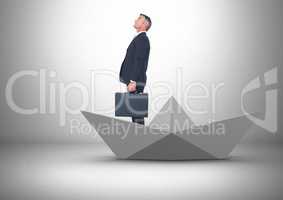 Businessman with briefcase in paper boat