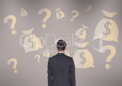 man in front of money on wall